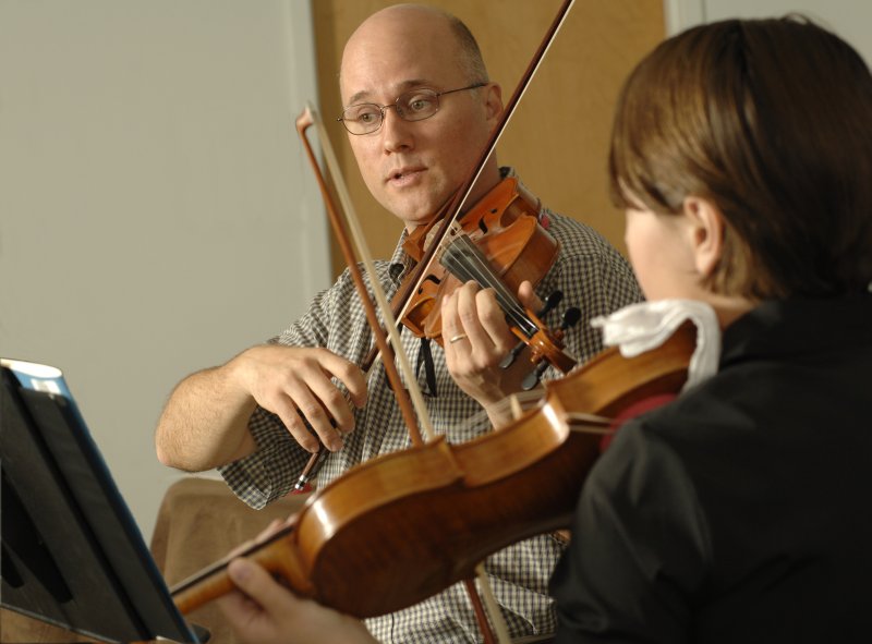 a violin teacher and student